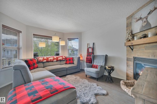 18 Southwick Point(E), Leduc, AB - Indoor Photo Showing Living Room With Fireplace