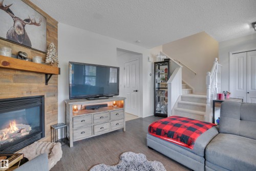 18 Southwick Point(E), Leduc, AB - Indoor Photo Showing Other Room With Fireplace