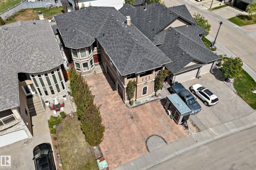 Spacious property featuring a multi-gabled roofline, a large stamped concrete driveway, and an attached three-car garage - 11024 179 Avenue, Edmonton, AB - Outdoor