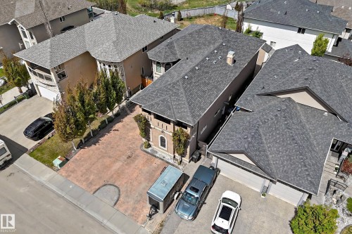 Aerial view showcasing the property with a stamped concrete driveway, three-car garage, and mature landscaping - 11024 179 Avenue, Edmonton, AB - Outdoor