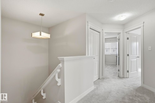 Upper-level hallway featuring light gray walls, white trim, and gray patterned carpeting - 2917 16A Avenue, Edmonton, AB - Indoor Photo Showing Other Room