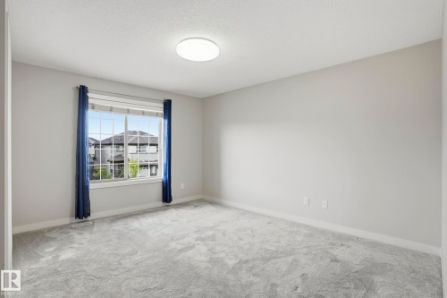 Light gray wall paint complemented by matching gray carpeting - 2917 16A Avenue, Edmonton, AB - Indoor Photo Showing Other Room