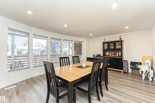 Dining area featuring light wood-finish flooring, recessed ceiling lighting, and a bay window with multiple panes - 17716 84 Ave, Edmonton, AB - Indoor Photo Showing Dining Room