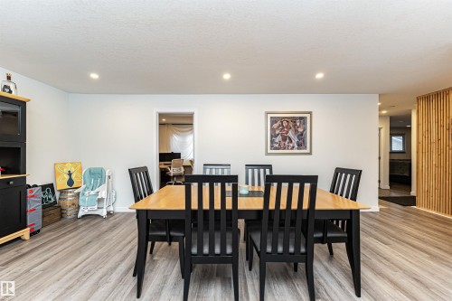 Spacious room featuring light wood-finish flooring, recessed lighting, and a light-toned wall color - 17716 84 Ave, Edmonton, AB - Indoor Photo Showing Dining Room