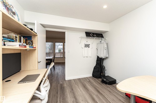 Dedicated workspace featuring built-in shelving, recessed lighting, and wood-finish flooring - 17716 84 Ave, Edmonton, AB - Indoor