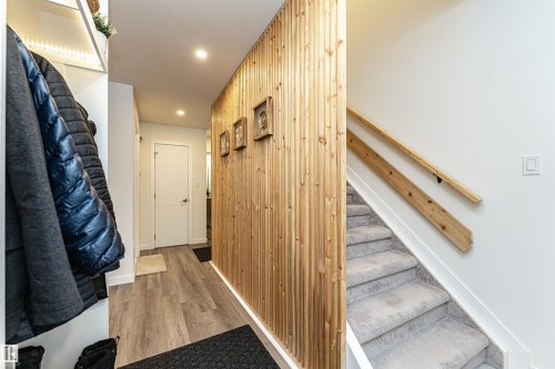 Entryway featuring wood-finish flooring, a wood slat accent wall, and recessed lighting - 17716 84 Ave, Edmonton, AB - Indoor Photo Showing Other Room