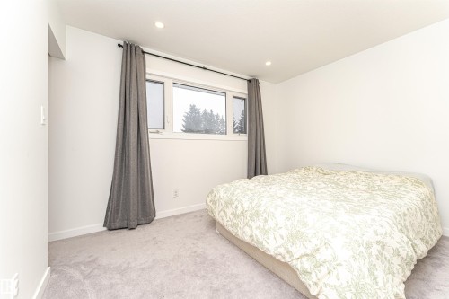 Bright room featuring recessed lighting, a large window, light-toned carpet flooring, and white baseboards - 17716 84 Ave, Edmonton, AB - Indoor Photo Showing Bedroom