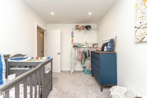 Recessed lighting illuminates the room, featuring light-toned carpeting and white walls - 17716 84 Ave, Edmonton, AB - Indoor