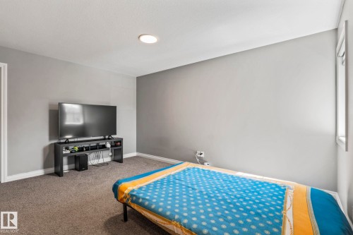 Room featuring gray wall paint, white trim, and a recessed ceiling light - 5142 23A Avenue, Edmonton, AB - Indoor Photo Showing Bedroom
