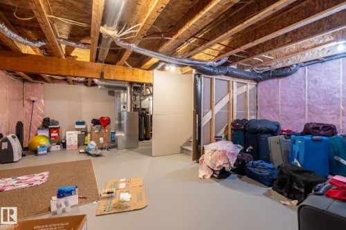 Lower level utility space featuring exposed wood joists, ductwork, and structural framing - 5142 23A Avenue, Edmonton, AB - Indoor Photo Showing Basement