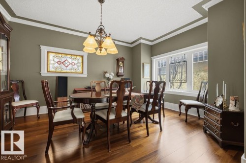 Classic styled dining room, with Brazilian walnut flooring, and crown molding. Perfect for entertaining. - 11137 81 Avenue, Edmonton, AB - Indoor Photo Showing Dining Room