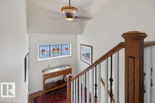 Extra wide staircase leading to the second floor, with stained glass insert. - 11137 81 Avenue, Edmonton, AB - Indoor Photo Showing Other Room