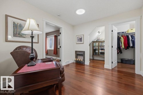 The primary suite also include a reading room, with solatube for natural light and a decorative antique ceramic insert gas fireplace. - 11137 81 Avenue, Edmonton, AB - Indoor Photo Showing Other Room