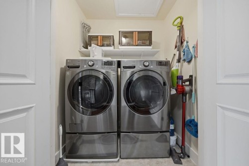Second floor laundry, discreetly tucked away in the landing closet. - 11137 81 Avenue, Edmonton, AB - Indoor Photo Showing Laundry Room