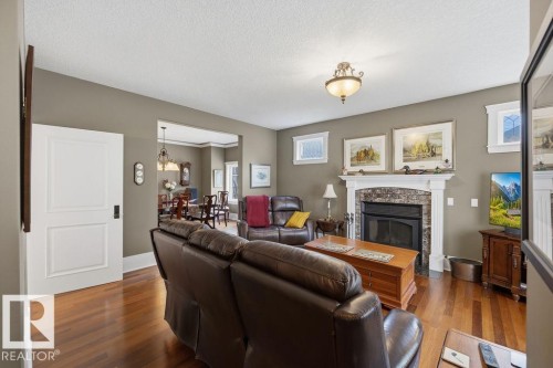 Spacious living room, with wood burning fireplace, Brazilian walnut hardwood, and 9' ceiling. - 11137 81 Avenue, Edmonton, AB - Indoor Photo Showing Living Room With Fireplace