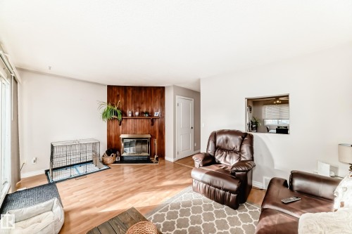 18 10453 20 Avenue, Edmonton, AB - Indoor Photo Showing Living Room With Fireplace