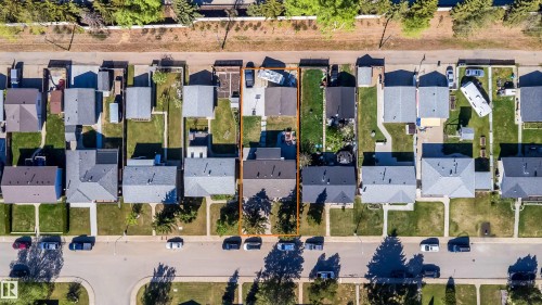 Aerial perspective highlighting a single-family home with a detached garage, front lawn, and rear yard - 14808 96 Street, Edmonton, AB -  With View