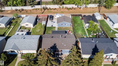 Overhead property view showcasing a light gray shingle roof, a paved driveway, and established green landscaping - 14808 96 Street, Edmonton, AB - Outdoor With View