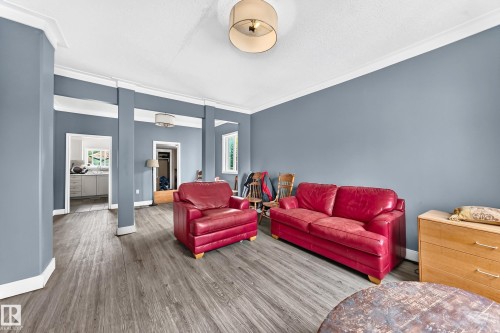 Wood-finish flooring with crown molding and ceiling light fixture - 12627 71 Street Nw, Edmonton, AB 