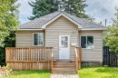 Light-toned siding exterior with a gabled roofline - 12627 71 Street Nw, Edmonton, AB 