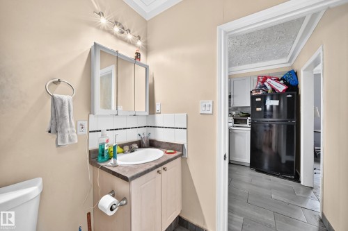 Vanity with an integrated sink and base cabinetry - 12627 71 Street Nw, Edmonton, AB 