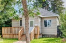 Light-colored siding exterior with a pitched shingle roof - 12627 71 Street Nw, Edmonton, AB 