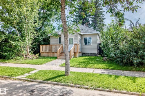 Single-story residence featuring light-colored siding and a gabled roof - 12627 71 Street Nw, Edmonton, AB 