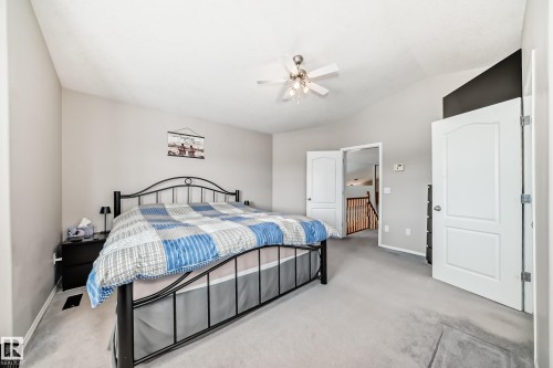 The property features a bedroom with a vaulted ceiling, a ceiling fan, and light grey carpeting - 8008 97 St, Morinville, AB - Indoor Photo Showing Bedroom