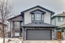 The property features a stone and siding exterior, a two-car garage, and a peaked roof - 8008 97 St, Morinville, AB  - Outdoor 
