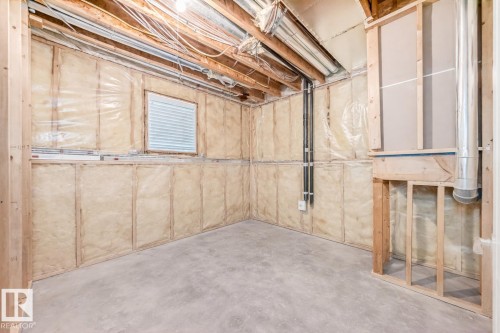 The unfinished basement features exposed wooden beams, insulation within the wall framing, and a concrete floor - 8008 97 St, Morinville, AB - Indoor Photo Showing Basement