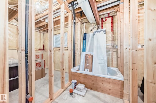 The property features an unfinished area with visible wooden framing and exposed insulation - 8008 97 St, Morinville, AB - Indoor