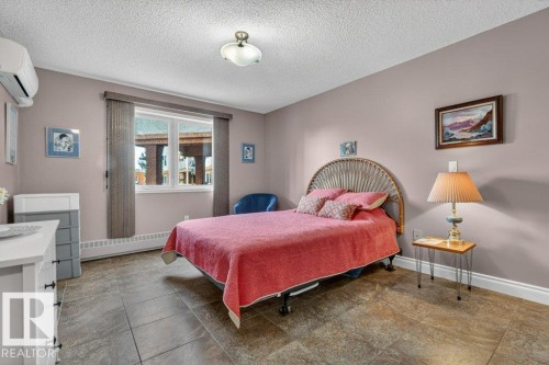 A very spacious primary suite complete with closet organizers. - 101 10903 21 Avenue Nw, Edmonton, AB - Indoor Photo Showing Bedroom