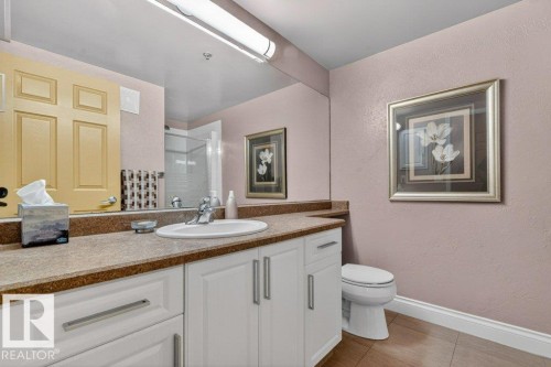 Cabinets have been refaced and new textured countertops added.  Comes complete with shower. - 101 10903 21 Avenue Nw, Edmonton, AB - Indoor Photo Showing Bathroom
