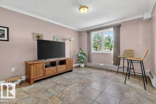This bedroom is presently being used as a den but the opening is still ready for french doors to be installed if required. - 101 10903 21 Avenue Nw, Edmonton, AB - Indoor
