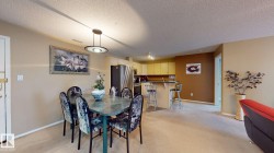 Open-concept dining area with a contemporary suspended light fixture - 