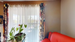 Floor-to-ceiling balcony doors with sheer and patterned curtain panels - 