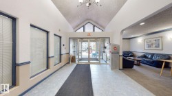 Vaulted ceiling entry foyer with tiled flooring and a carpeted runner - 