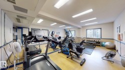 Fitness room featuring recessed lighting, a mirrored wall, and wood-finish flooring - 