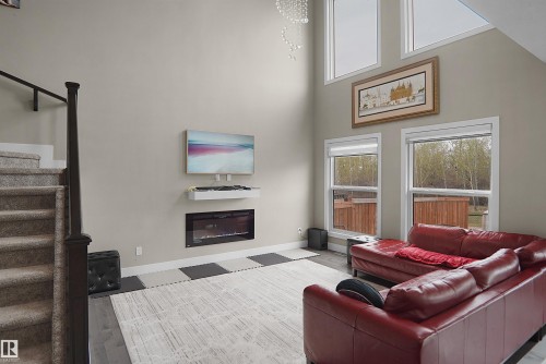 Soaring ceilings with upper architectural windows and two lower windows provide ample natural light - 6108 173 Ave, Edmonton, AB 