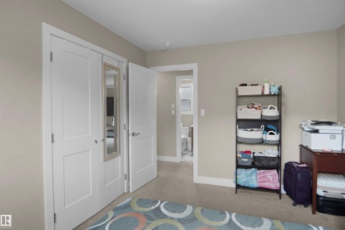 Neutral-toned walls complement the carpeted flooring - 6108 173 Ave, Edmonton, AB 