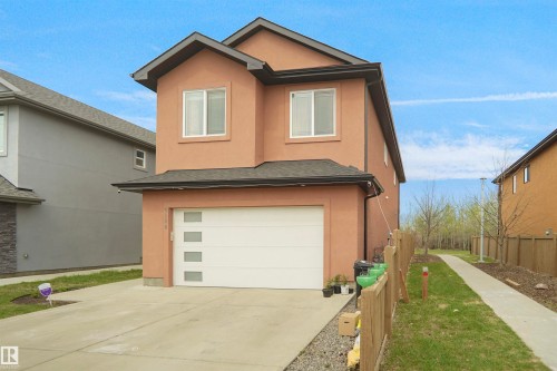 Contemporary two-story stucco exterior with a prominent attached garage - 6108 173 Ave, Edmonton, AB 