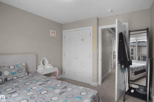 Bedroom featuring neutral wall color, white trim, and carpet flooring - 6108 173 Ave, Edmonton, AB 