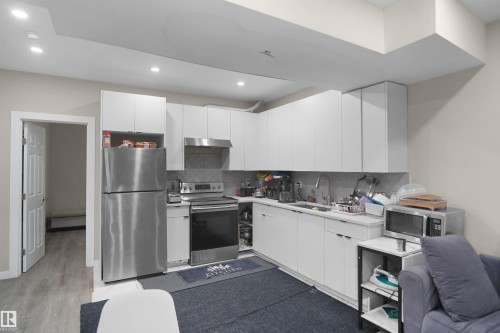 Modern kitchen featuring white cabinetry, stainless steel appliances, and recessed lighting - 6108 173 Ave, Edmonton, AB 