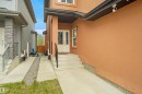 Stucco exterior with a contrasting soffit, white framed window, and a white front entry door with decorative glass inserts - 6108 173 Ave, Edmonton, AB 