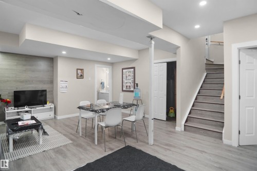 Finished lower level featuring recessed lighting, light-toned walls, wood-finish flooring, and a textured accent wall - 6108 173 Ave, Edmonton, AB 