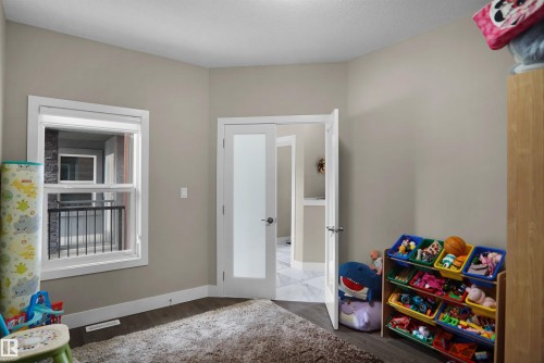 Neutral wall paint complements wood-finish flooring - 6108 173 Ave, Edmonton, AB 