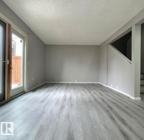 Living area featuring light gray LVP. - 1312 Lakewood Road W, Edmonton, AB - Indoor Photo Showing Other Room