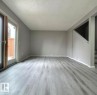 Living area featuring light gray LVP. - 1312 Lakewood Road W, Edmonton, AB  - Indoor Photo Showing Other Room 