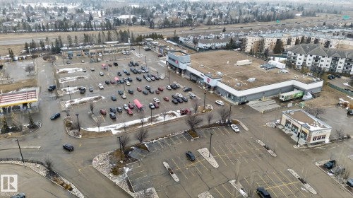 Aerial view showcasing commercial buildings, parking lots, and surrounding residential structures - 423 2430 Guardian Road, Edmonton, AB - Other