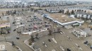 Aerial view showcasing commercial buildings, parking lots, and surrounding residential structures - 423 2430 Guardian Road, Edmonton, AB  - Other 
